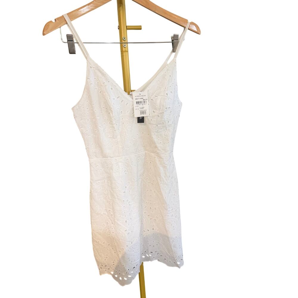 Speechless white dress features an eyelet design and a V-neckline